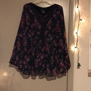 Lace up neckline. Black bellowing top.